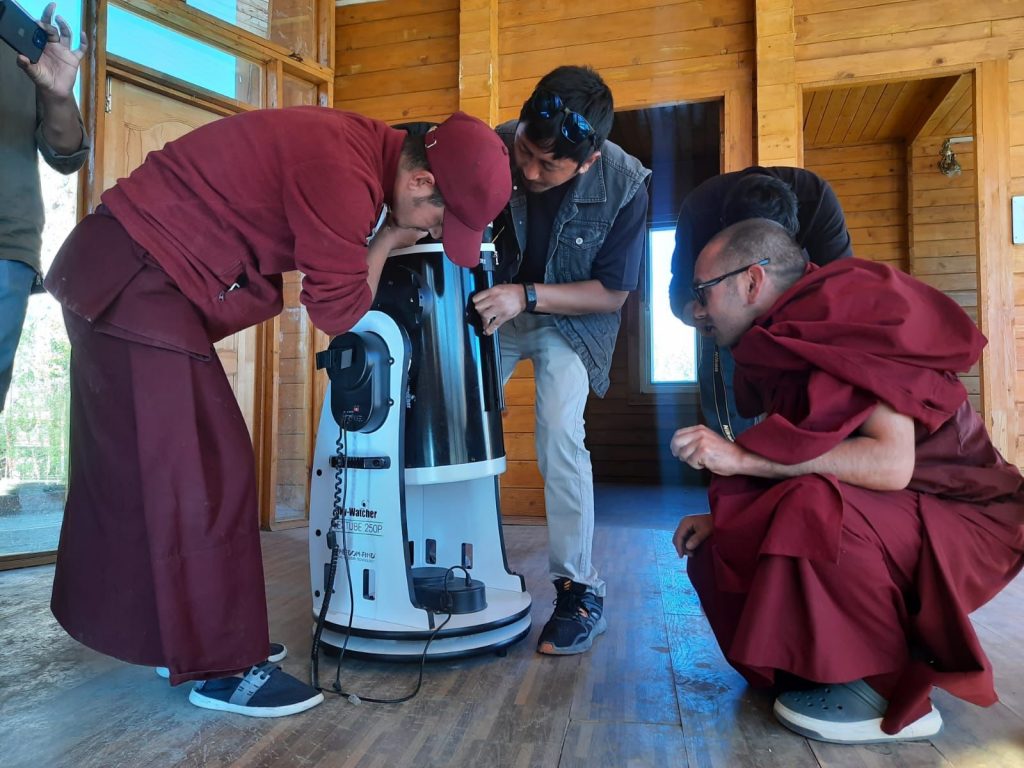 Our project team helping to setup the telescope at the monastery